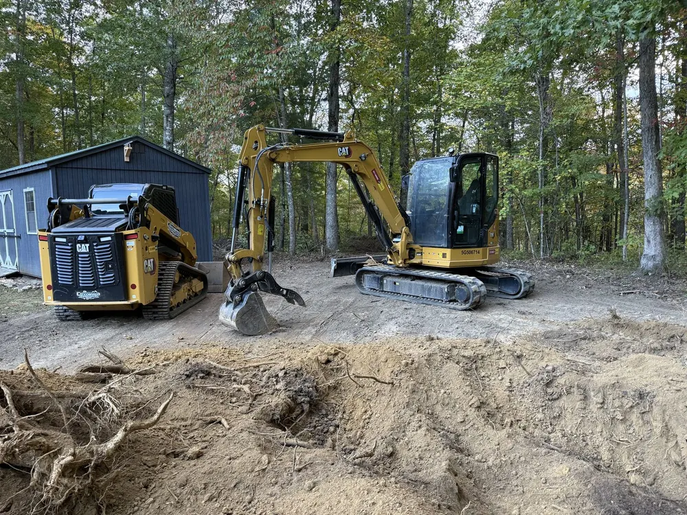 Crew using heavy equipment to perform grading on a residential site