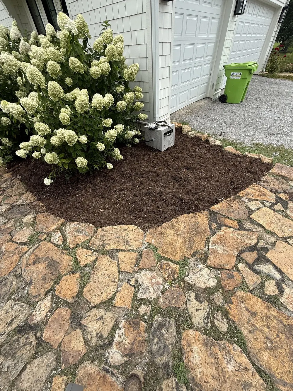 Hand-laid stone patio with detailed masonry edges